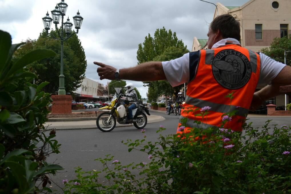 Robert Magann points the rider in the right direction at the Otho/Byron Streets roundabout.