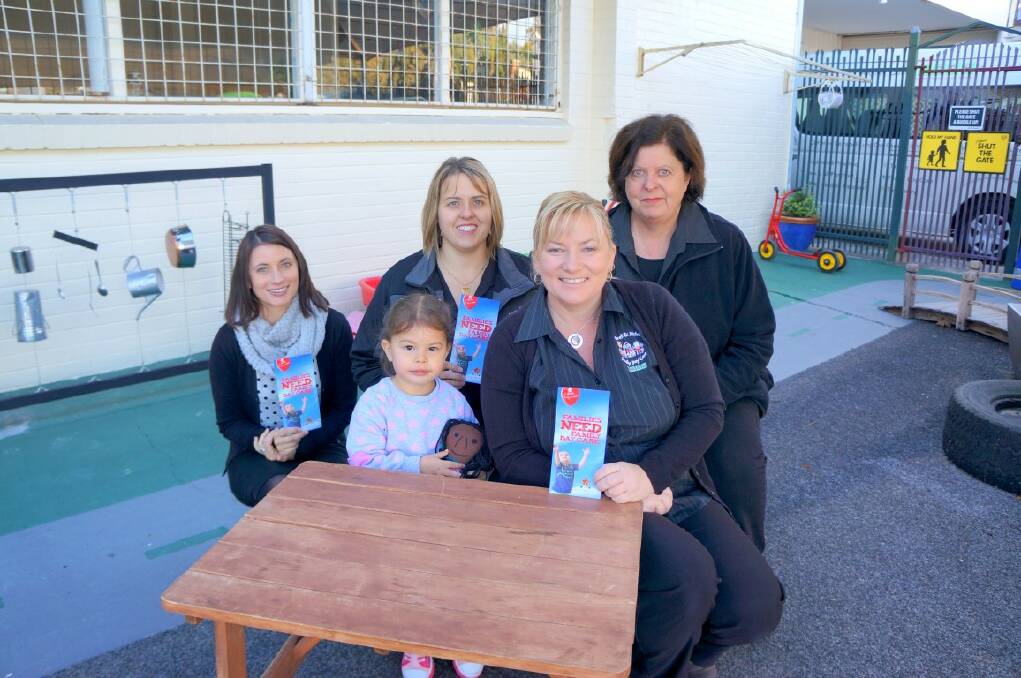 Back: UNDER PRESSURE: IDFS Family Day Care admin officer Carly McMahon, child development co-ordinator Lisa Reece, admin officer Robyn Price and sitting, client Georgia McMahon and manager Lisa Szumowski.
