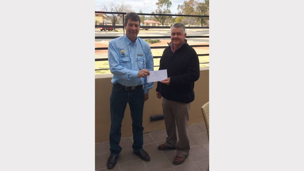 DONATION: Inverell RSM Fishing Club president Peter Black hands over a cheque to Kerry White from Inverell Prostate Cancer Support Group.