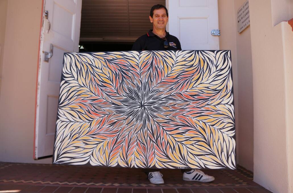 ARTIST: Rod McIntosh with his painting Ngarran (Medicine Bush), an explosion of eurah leaves, at the Inverell Art Gallery.