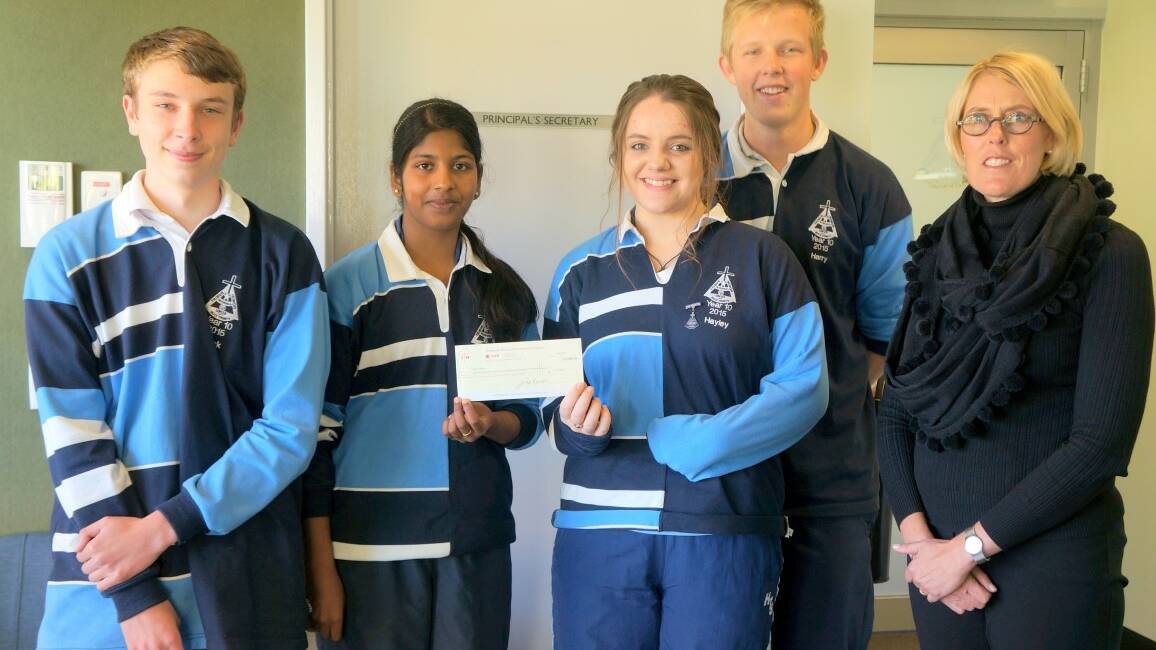 DONATION: Year 10 students Jack Stader, Harry Jorgensen, Littisha Varghese and Hayley Duffy with Holy Trinity principal Jillian Rainger and the cheque for $1102.70.