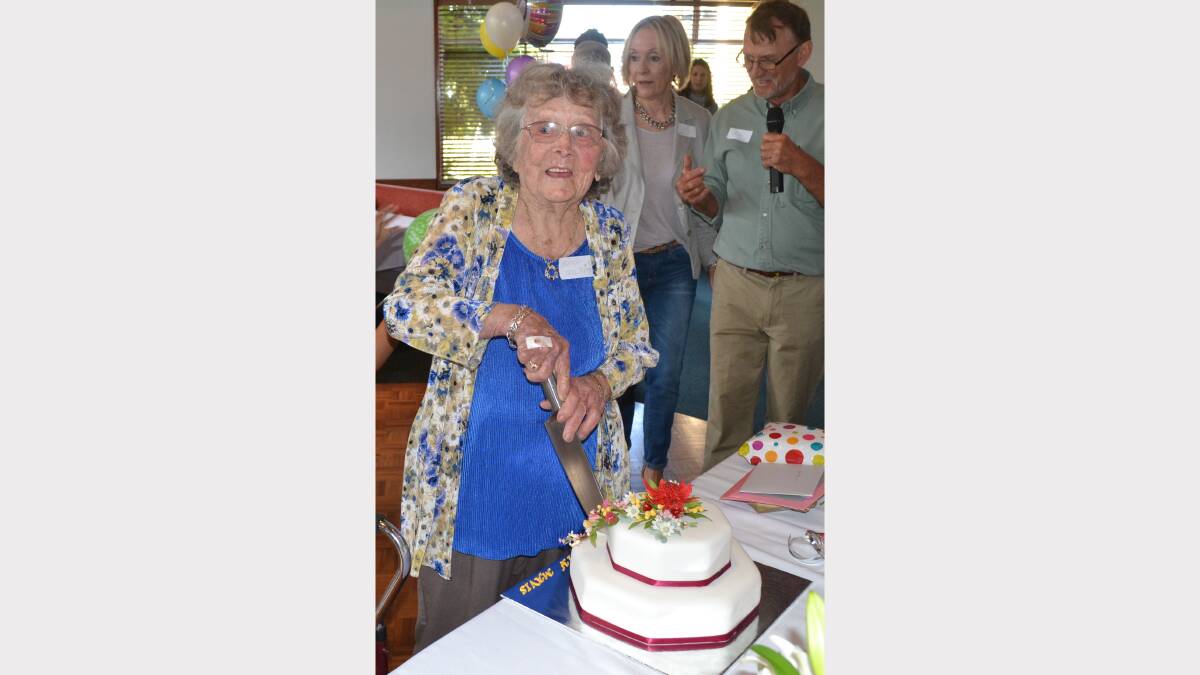 Mavis Hall cutting her 100th birthday cake.