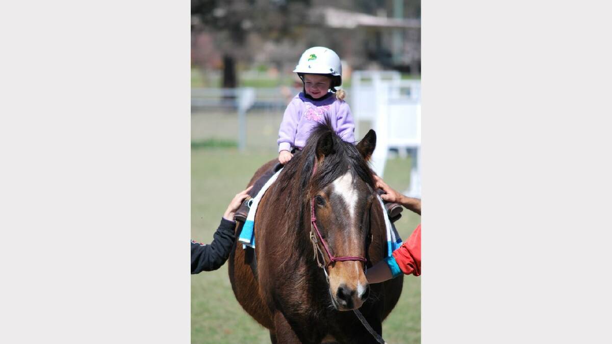 Two-year-old Nikeyta Owen trying her skills on the Vaulting horse.