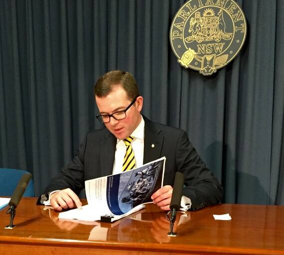 Joint Select Committee on Companion Animal Breeding Practices chairman Northern Tablelands MP Adam Marshall reviews the printed report.