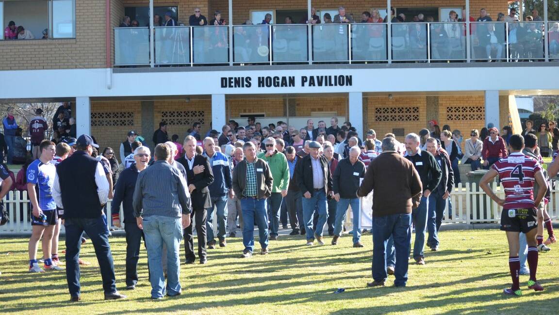 OLD BOYS: Hawks Old Boys make their way onto the ground to form a guard of honour for the A grade on Saturday.