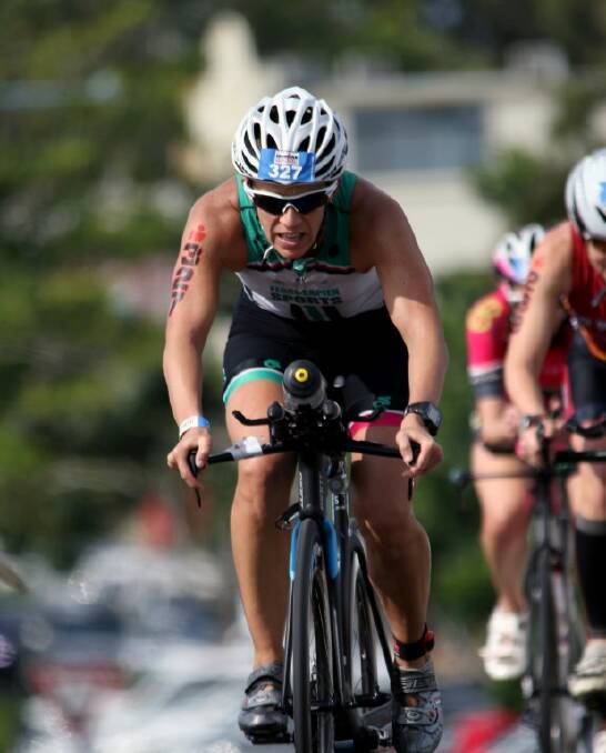 EFFORT: Kasey Willoughby rides hard in the bike leg of the Iron Man event.			          PHOTO courtesy of WITSUP.COM