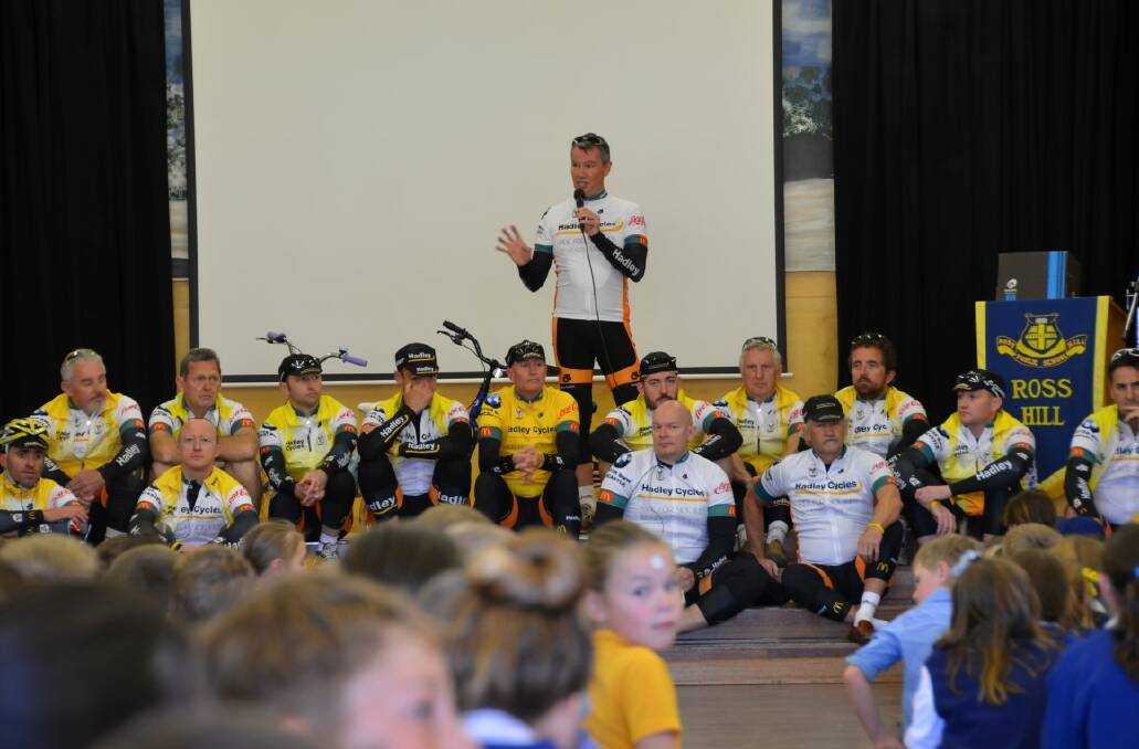 RMH rider Russell Bingham speaks to Ross Hill Public School before announcing $11,176 has been raised to assist sick kids.