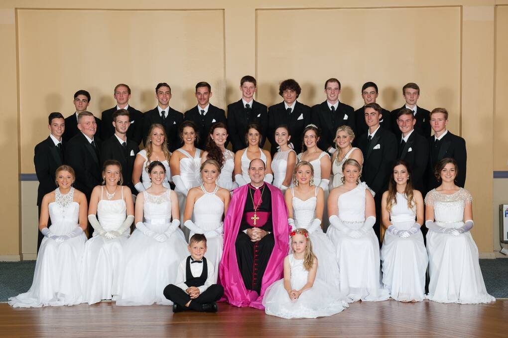 ALL DRESSED UP: The 2015 Debutantes and their escorts. Back row: Jack Roussos, Alex Ticehurst,  Declan Drake, Billy Stewart, Tristan Blair, Cody Dwyer, Mitch Lennon, Wade Stewart and Jack Staader. Middle row: Mitch Myler, Justin Oakenfull, Charlie Dolbel, Maggie Thomas, Sarah Lennon, Eboni Luxford, Kate Lennon, Kelsie Dodd, Laura Beddie, Chloe Campbell, Tom Scoble, Sage Cook and Dougal Strahley, and (front row) Kristen Sparke, Sarah Flick, Jessie Ryder, Sally Noble, Bishop Micheal Kennedy, Ashley Ford, Emily Moffitt, Valentina Cabitza, Ashleigh Campbell with page boy Caleb Radford and Page Girl Ella Glasson. Photo by RACHEL MESZAROS PHOTOGRAPHY
