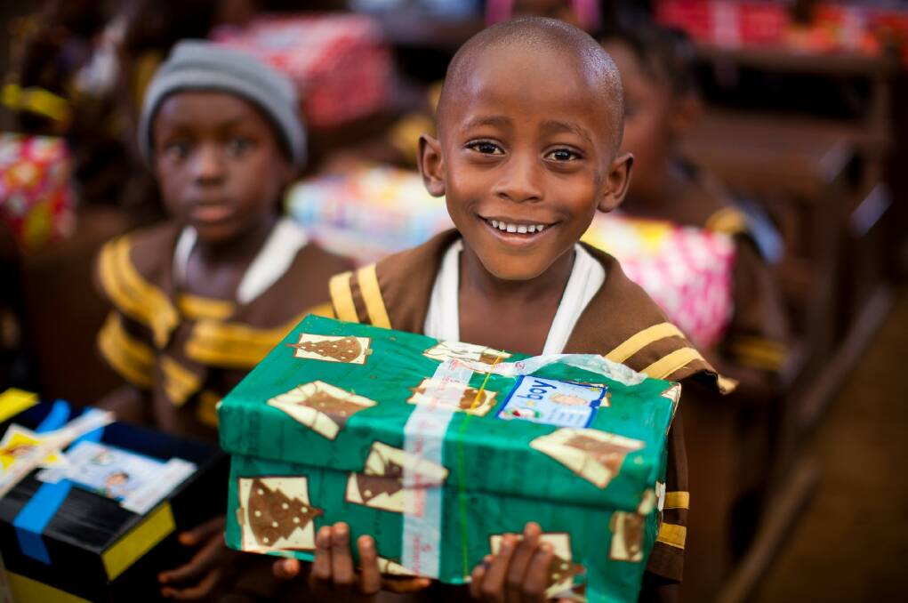 A child in Liberia receiving a Christmas box. Photo courtesy of Samaritan’s Purse.