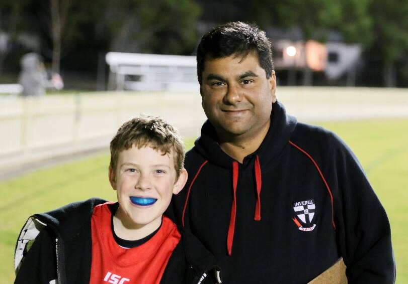 ACHIEVEMENT: Benjamin Cox and Inverell Auskick coaching co-ordinator Gerry Taveira.
