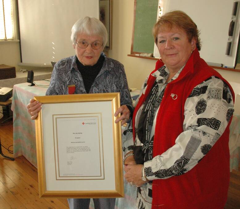 PRESENTATION: Joy Ayling accepts her parchment and brooch from Red Cross zone represetative Helen Leslie.