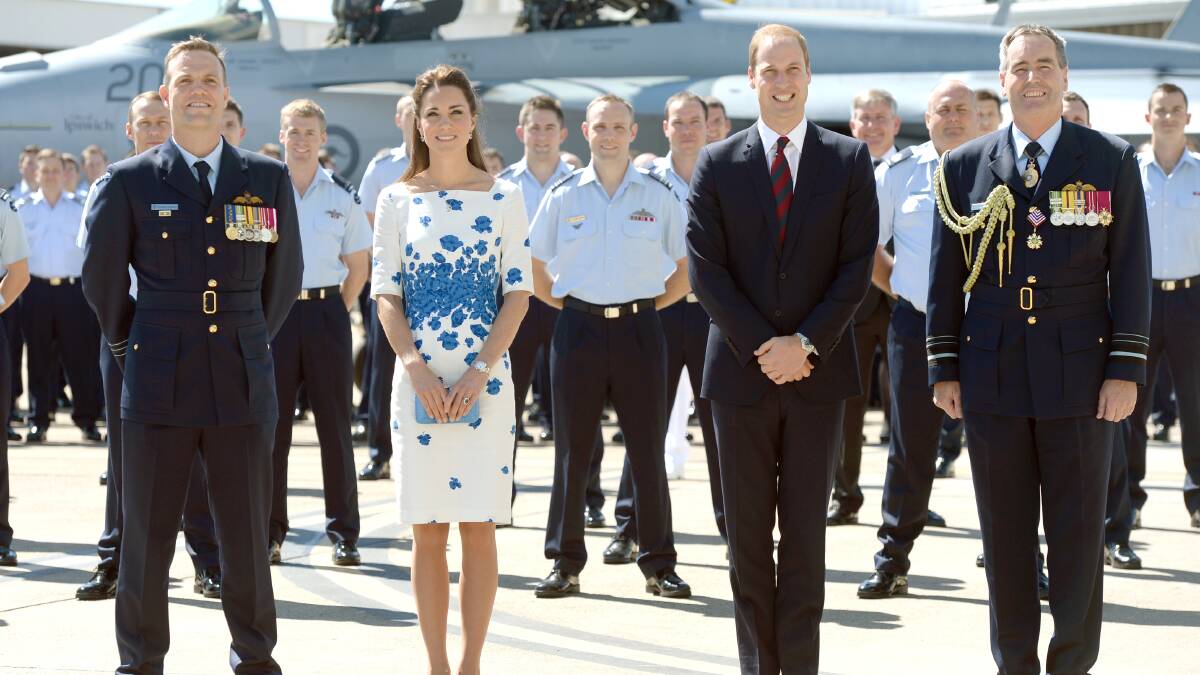  Catherine, Duchess of Cambridge and Prince William, Duke of Cambridge pose with members of 1 Squadron at the Royal Australian Airforce Base at Amberleyon April 19, 2014 in Brisbane, Australia. The Duke and Duchess of Cambridge are on a three-week tour of Australia and New Zealand, the first official trip overseas with their son, Prince George of Cambridge. Photo: Pool/Samir Hussein/WireImage.