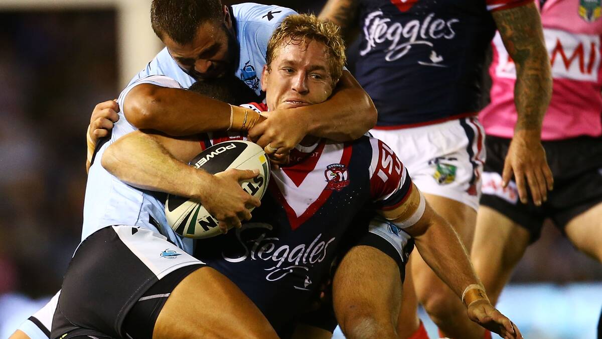 Mitchell Aubusson of the Roosters is tackled during the round seven NRL match between the Cronulla-Sutherland Sharks and the Sydney Roosters at Remondis Stadium on April 19, 2014 in Sydney, Australia. Photo: Mark Nolan/Getty Images.