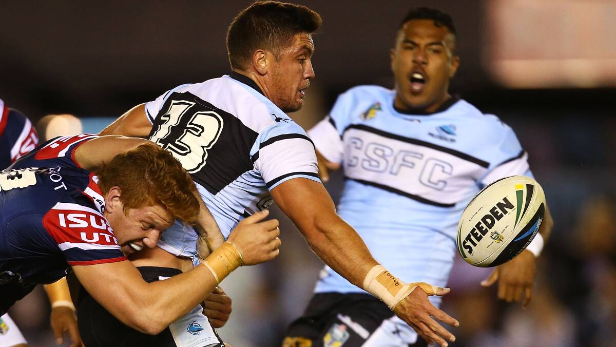 Chris Heighington of the Sharks offloads during the round seven NRL match between the Cronulla-Sutherland Sharks and the Sydney Roosters at Remondis Stadium on April 19, 2014 in Sydney, Australia. Photo: Mark Nolan/Getty Images.