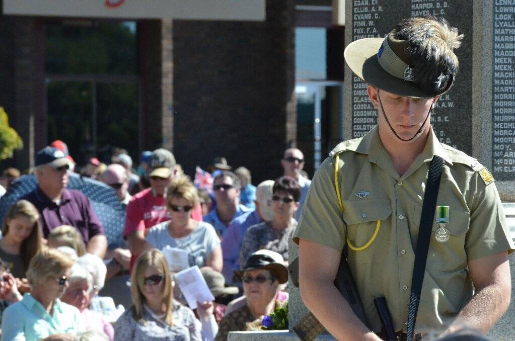 SOMBRE: The crowd pauses to remember the fallen at yesterday’s Anzac Day ceremony.