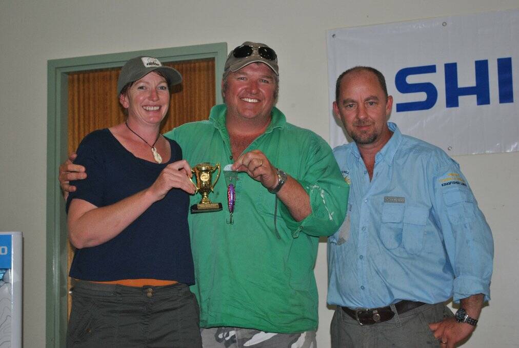 TOP PRIZE: Champion Rowan O'Brien (centre) receives his trophy from Inverell Fishing and Hunting owners Mick and Wendy Shelton.