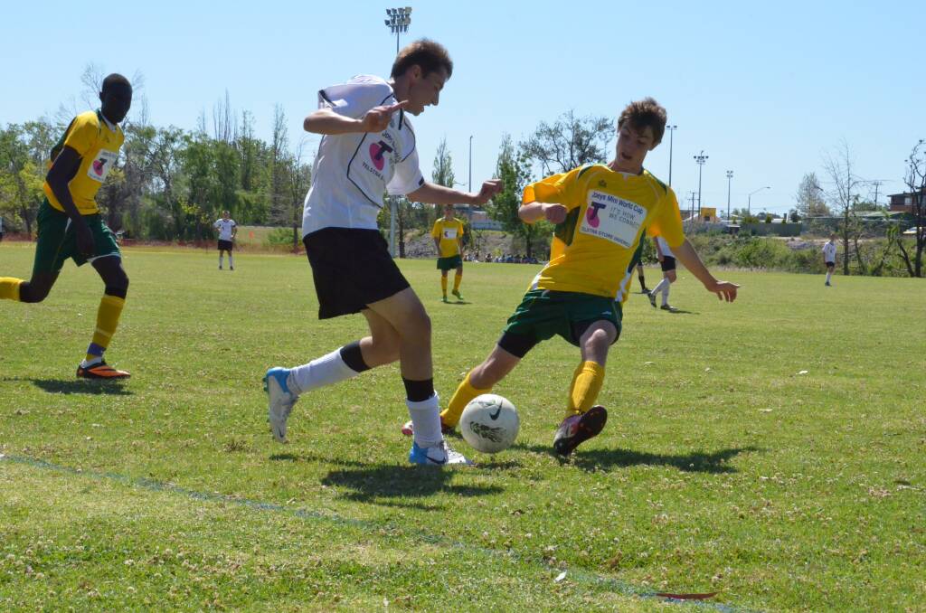 Germany's Max Zimmer moves in for the ball under the feet of Australia's Austin Paul in the final.