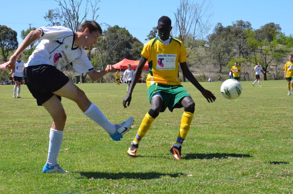 Germany's Max Zimmer was an active player in the final. He's flicking the ball from under Australia's Dut Garang.