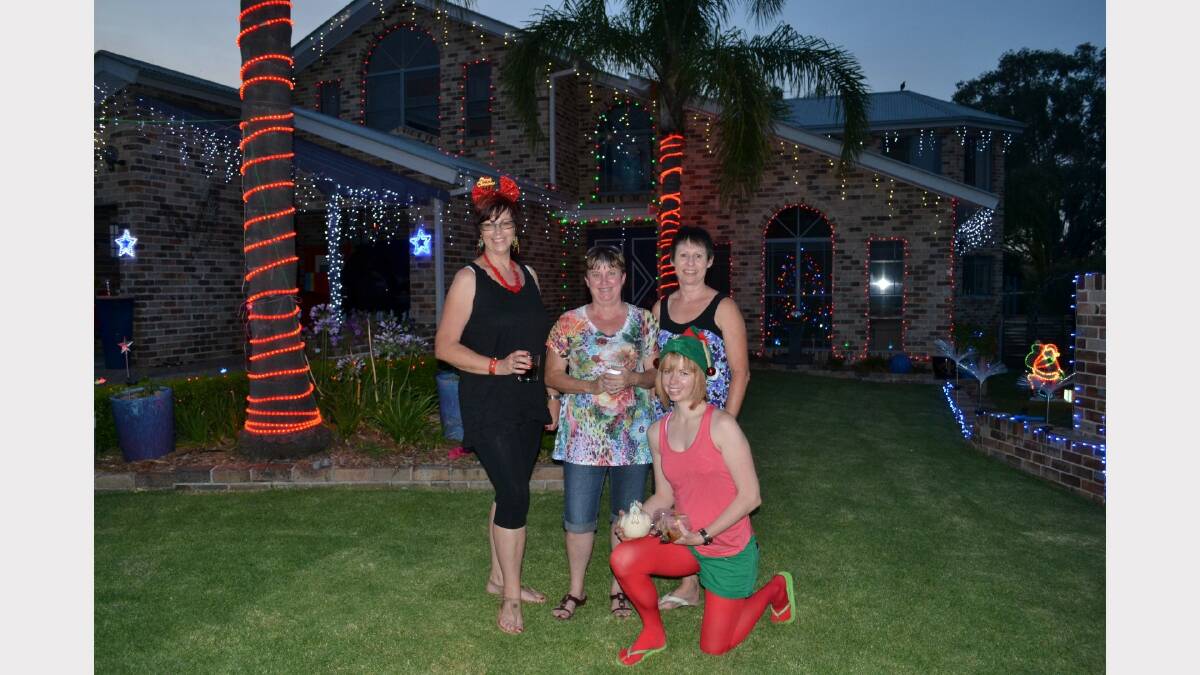 Sunday night lights on Miles Street: Coral Whitbread, Sue Fox, Judith Kirk and Renee Whitbread who's holding block mascot Henny Penny.
