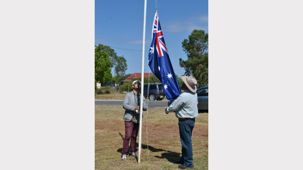 Australia Day Ambassador Joseph Tawadros raised the Delungra flag with help from event organiser Graeme Wright.
