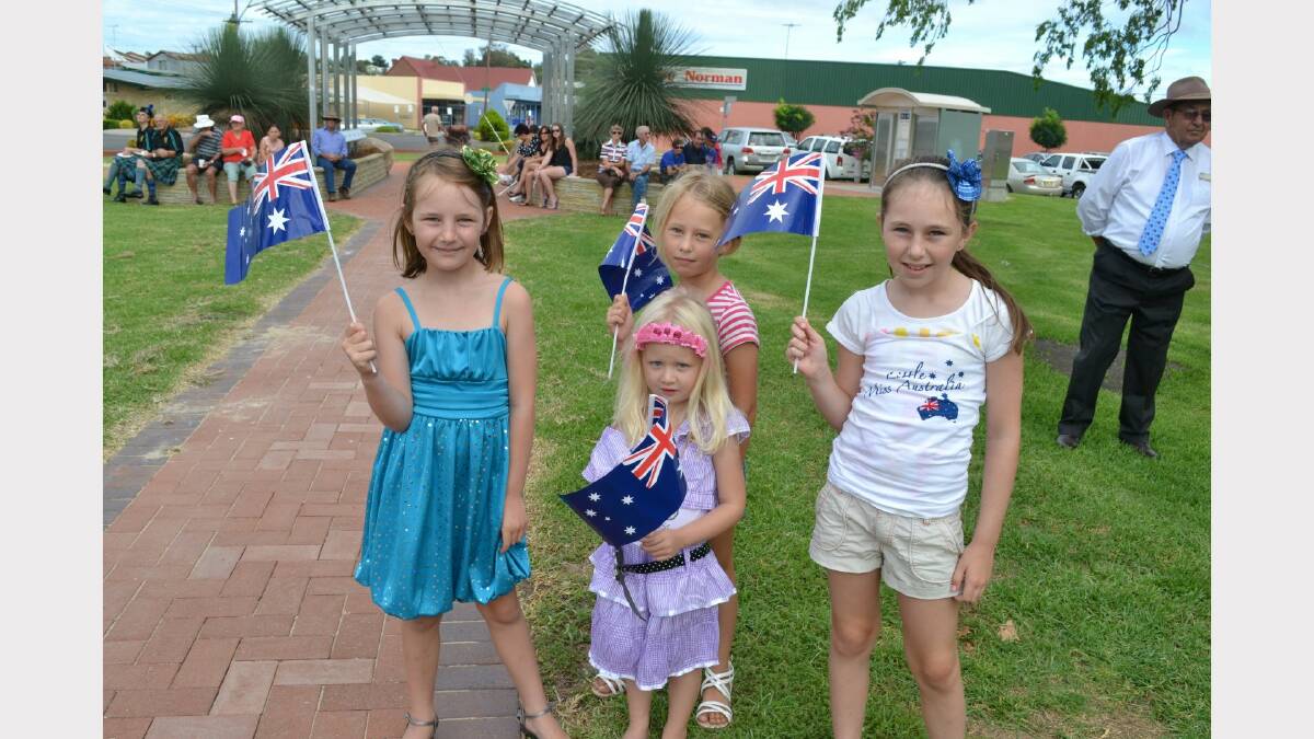 Alice McInnes, Charlotte McInnes, Hollie Purvis and Emma McInnes wave the Aussie flag in Victoria Park on Australia Day.