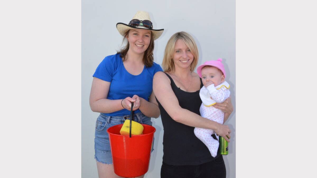 Student Aimee Miller visits with Nikki-Ann Watts and her daughter Amelia McNulty while NIkki-Ann's car is washed.