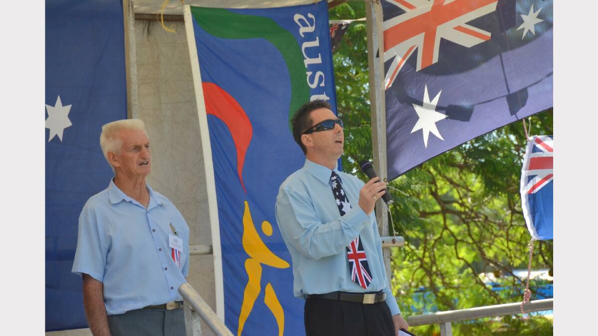 Delungra's District Development Council chair Jim Townsend stands to attention as Inverell's Director of Tourism, Peter Caddey sings the Australian National Anthem.