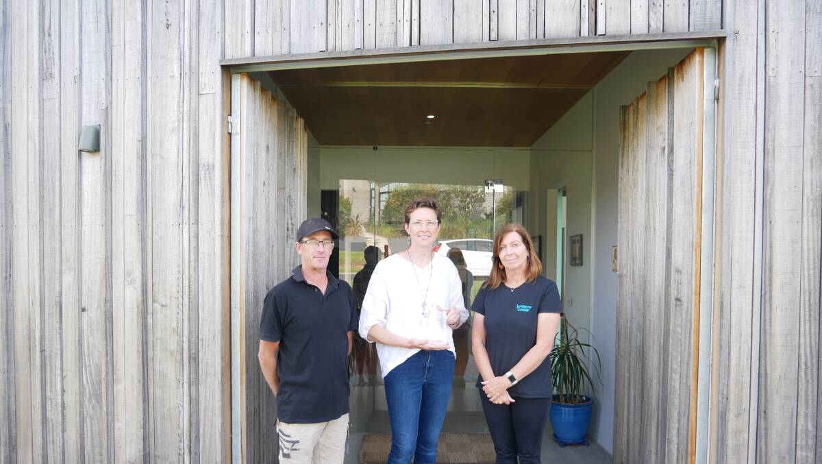 FROM LEFT: Owner and builder Peter Brannelly, architect Kelli Rieck, and Anne Brannelly (who designed the interiors) stand at the front entrance of the award winning Tura Beach home. Photo: Ellouise Bailey