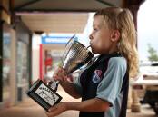 Max Johnson, 6, taking a sip from the the Best Mullet Of Them All trophy. Picture: Simone De Peak