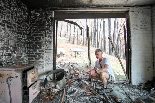 Greg Webb at the remains of his home in Lake Conjola on the NSW south coast in February 2020 after the Black Summer bushfires. Picture by Adam McLean