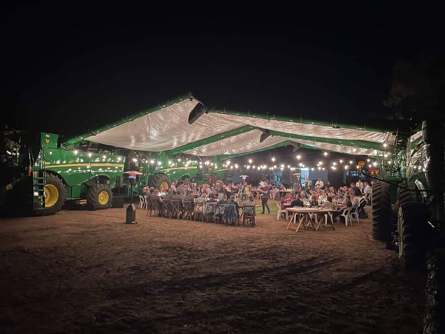 MECHANICAL MATRIMONY: Kingsley and Chloe Vandersee used combine harvesters to build their reception venue. Photos: Dux Till Dawn Photography. 