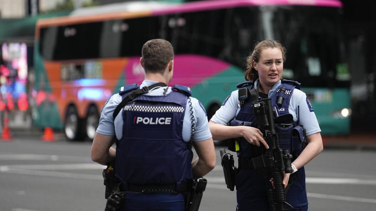 Armed police officers stand outside a hotel housing a team from the FIFA Women's World Cup following a shooting in Auckland, New Zealand. Picture by AP Photo/Abbie Parr