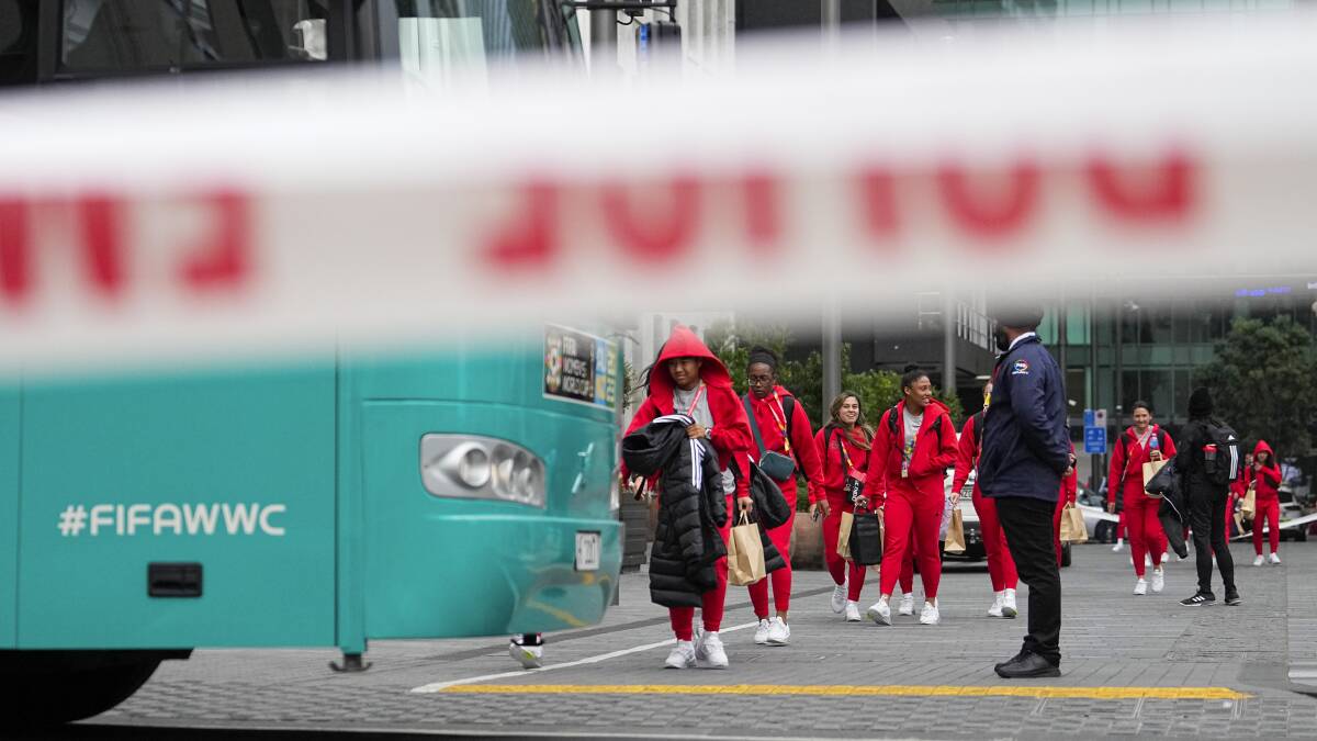 The Philippines' women's soccer team walk to their team bus following a shooting near their hotel in Auckland. Picture by AP Photo/Abbie Parr