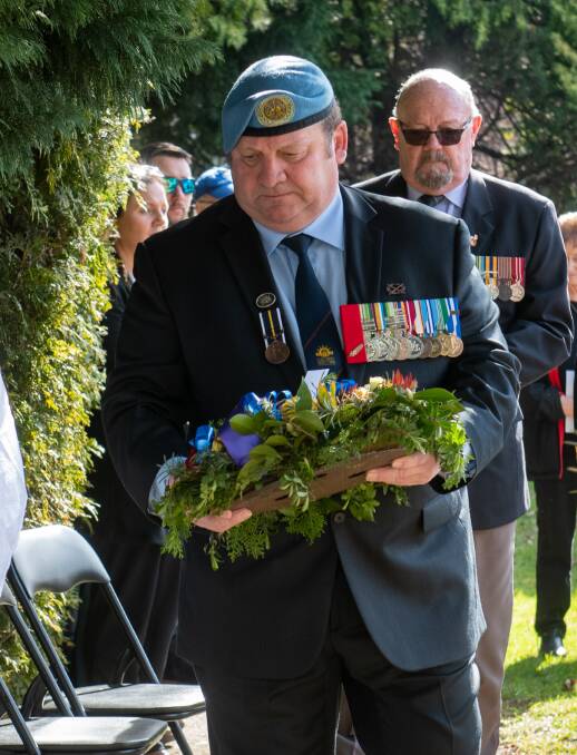 Launceston RSL secretary Pete Williams laying a wreath on Vietnam Veterans' Day. 