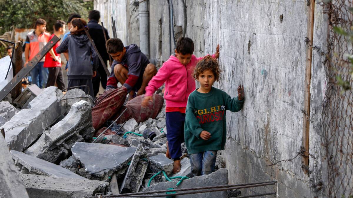 People gather near a destroyed building following an Israeli air strike in central Gaza. Picture Shutterstock