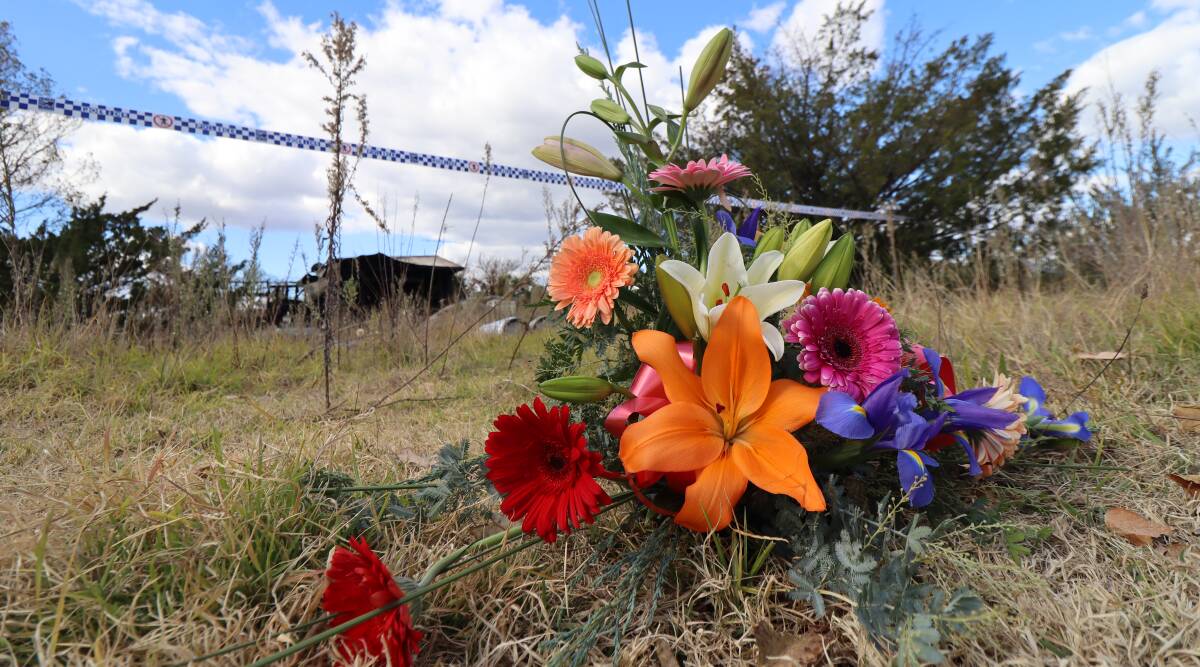 MOURN: Flowers grace the outside of the burnt Museum Street home as the Tingha community mourns the loss of one of their own. Photo: Jacinta Dickins