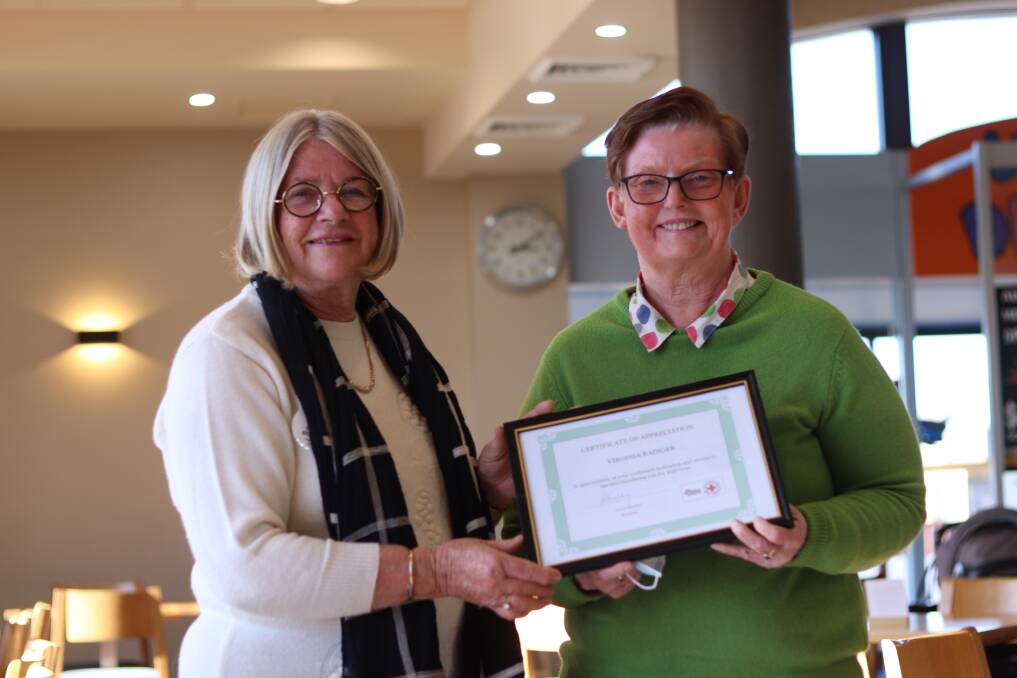 REWARD: Red Cross president Cheryl Strahley presented Virginia Rainger with a certificate of appreciation for her role as merchandiser. Photo: Jacinta Dickins