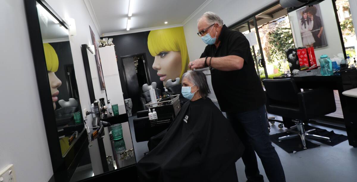 ON THE HOOK: Ian Hooker said he can have up to six people waiting on the line calling to arrange a hair appointment. Photo: Jacinta Dickins