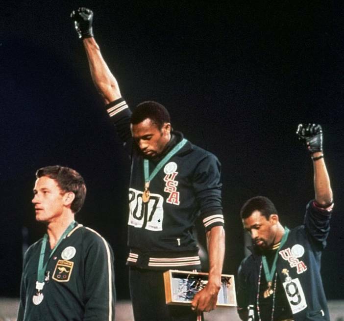 Peter Norman (left) with US athletes Tommie Smith, centre, and John Carlos at the 1968 Olympic Games. Photo: Ap