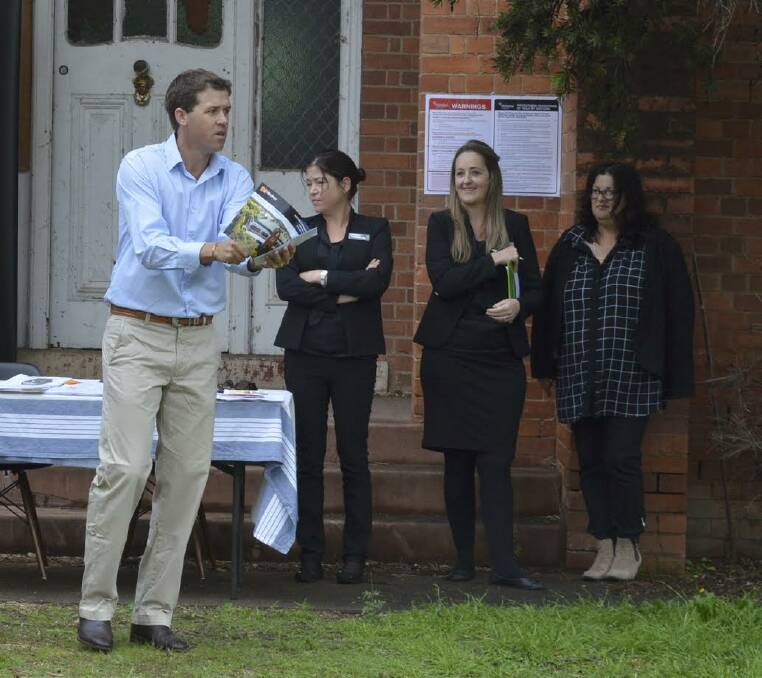 SOLD: Auctioneer Robbie Bloch leads the action at the sale of the former Catholic convent on Vivian St on Saturday, as LJ Hooker's Amanda O'Cass, Lisa Moore and Jenni Devlin look on. Photo: Harold Konz