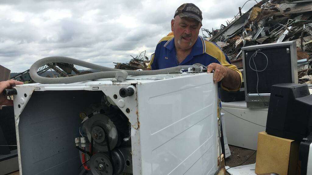 Lions member Mick Mitchell removes a washing machine during a previous whitegoods collection.