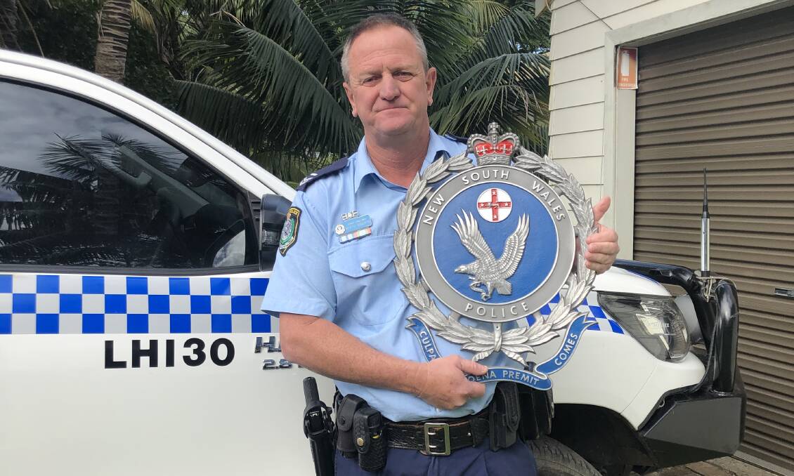 Senior Constable Heath Roberts with the crest on Lord Howe Island.