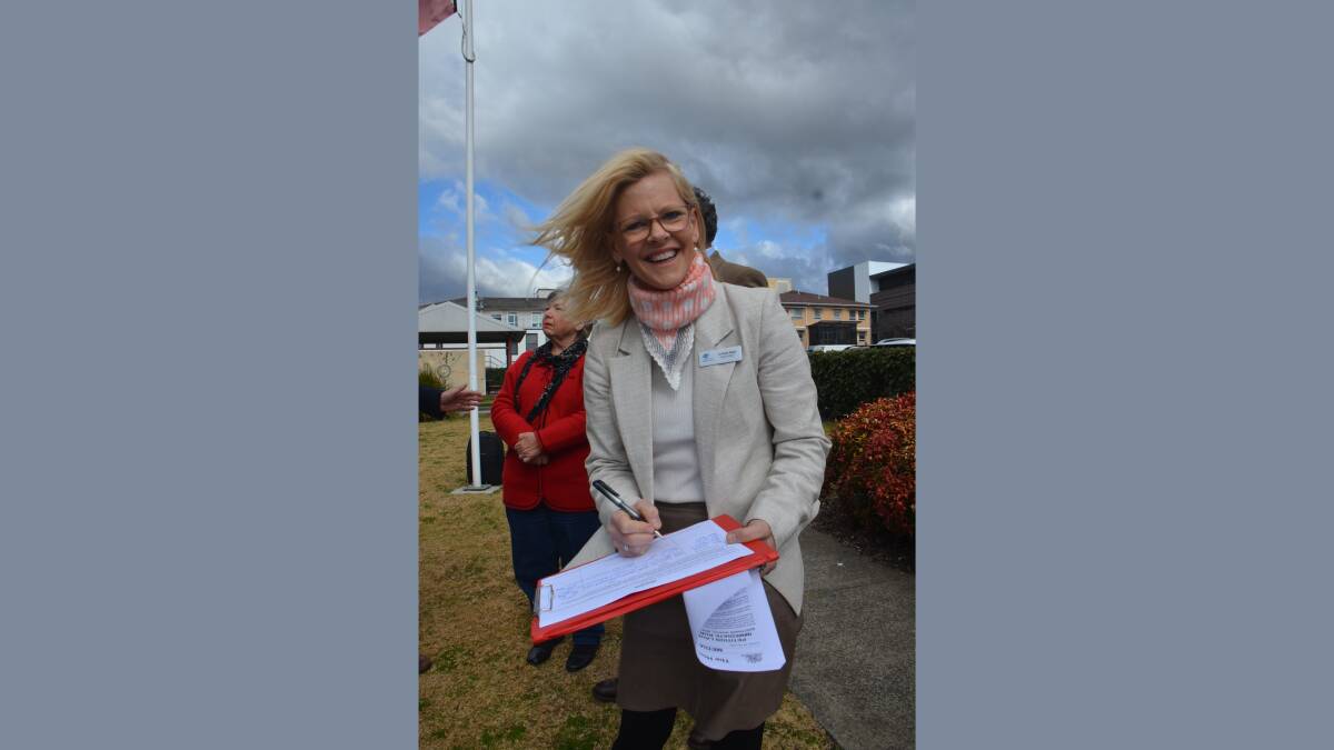 SIGNING ON: Inverell Shire deputy mayor Kate Dight signs the petition outside Armidale Hospital on Tuesday. Picture: Laurie Bullock