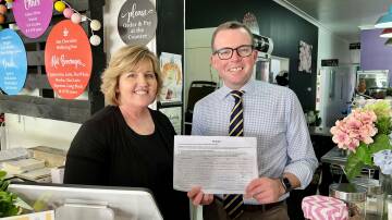 Owner of Inverell's Freckles Cafe, Jenny Thomas, with MP Adam Marshall and the petition, which is available to sign at businesses throughout the electorate.