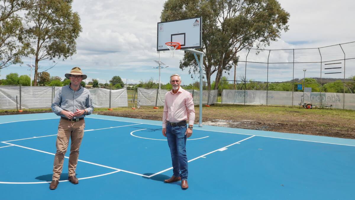 ON THE COURT: MP Adam Marshall and mayor Paul Harmon inspect progress work on the new outdoor youth space and basketball court.