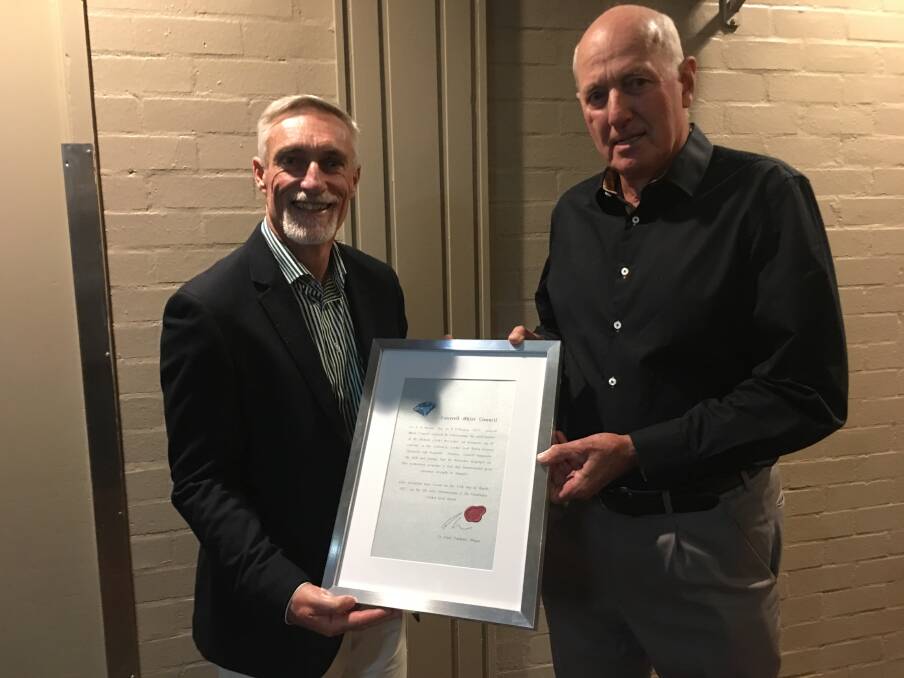 Inverell mayor Paul Harmon with Rick McCosker on Saturday night, when the mayor presented McCosker with a certificate from the council.