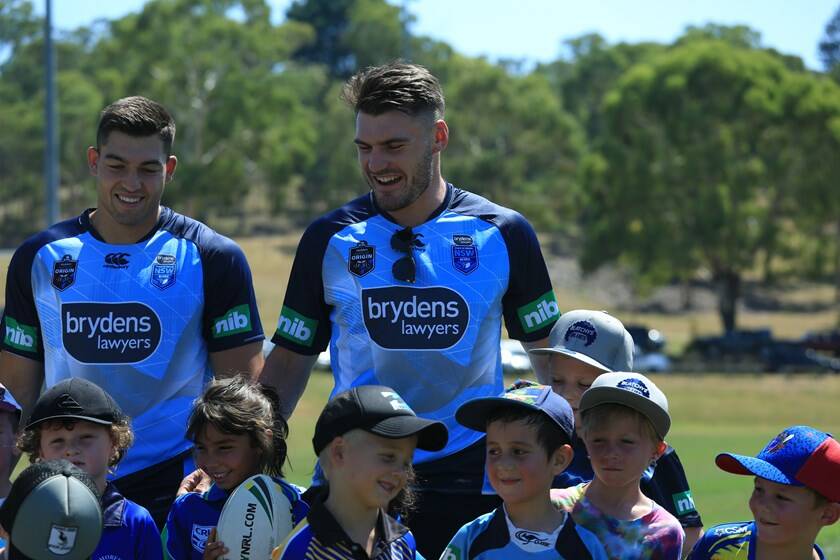 KINGS OF THE KIDS: Nic Cotric and Angus Crichton go the charm offensive at the Blues' kids clinic at the University of New England on Saturday. Photo: NSWRL 