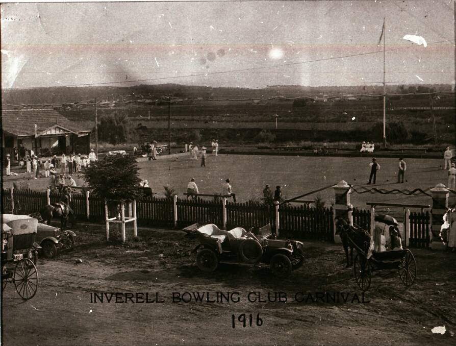 A scene from 1916: The Inverell Bowling Club during a carnival with cars and buggies drawn up to the fence.