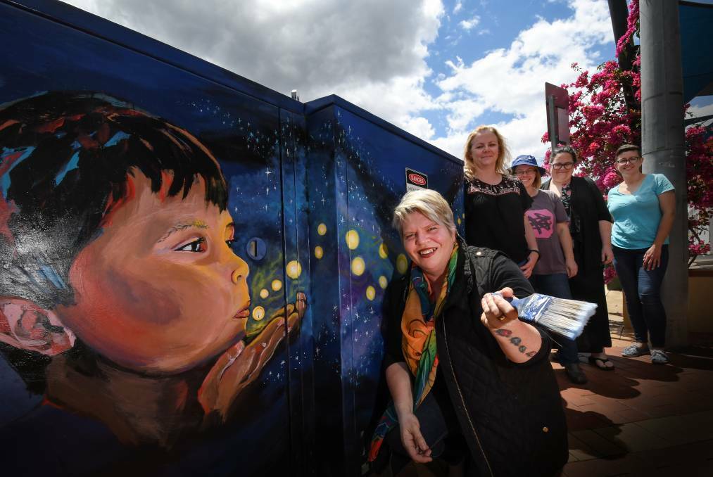 POWERFUL: The Tamworth Regional Art Collective with one of its latest pieces in the CBD. From left: Jodie Herden, Karen Balsar, Joanne Stead, Jody Blackwell and Leah Dryden. Photo: Gareth Gardner 231017GGC003