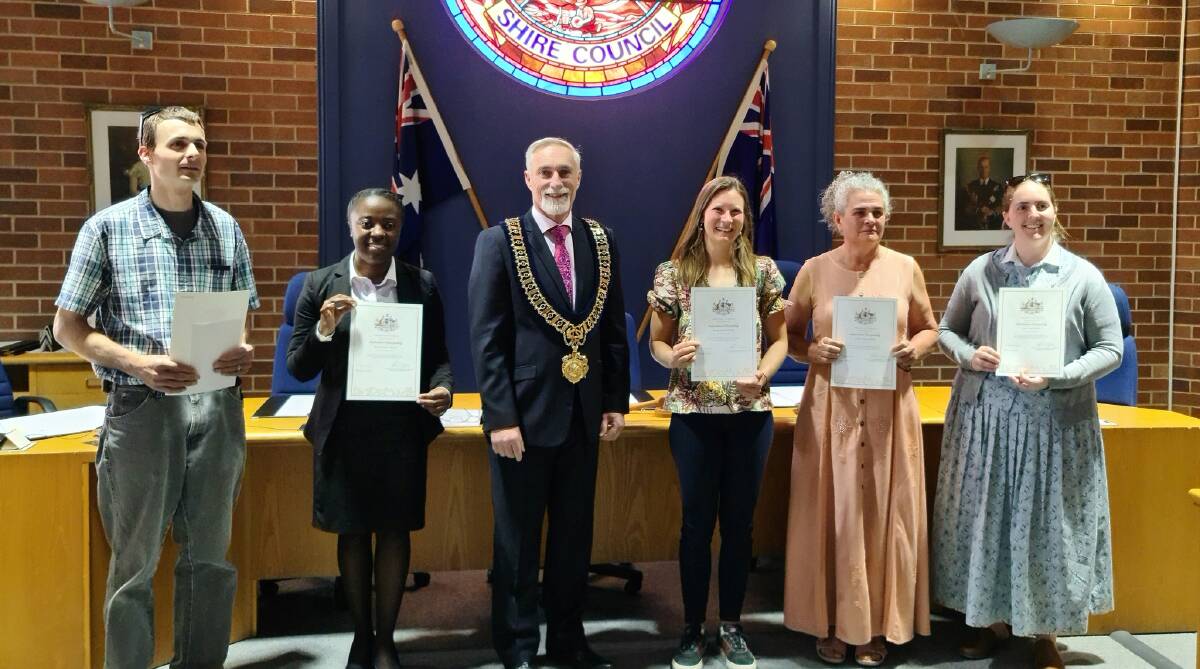 Inverell Shire mayor Paul Harmon welcomes the five newest Australian citzens after the ceremony at council chambers. 